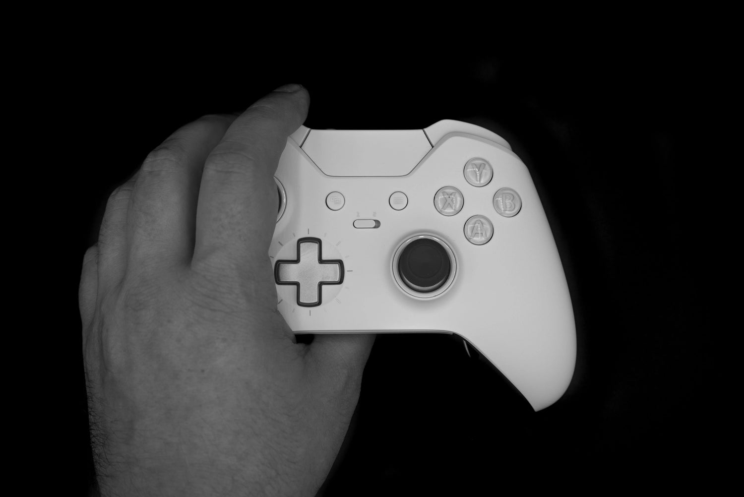 A gamer holding white xbox controller